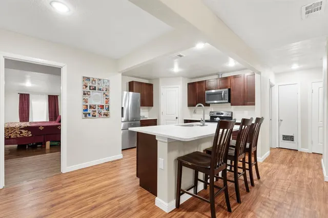 a view of kitchen with cabinets table and chairs