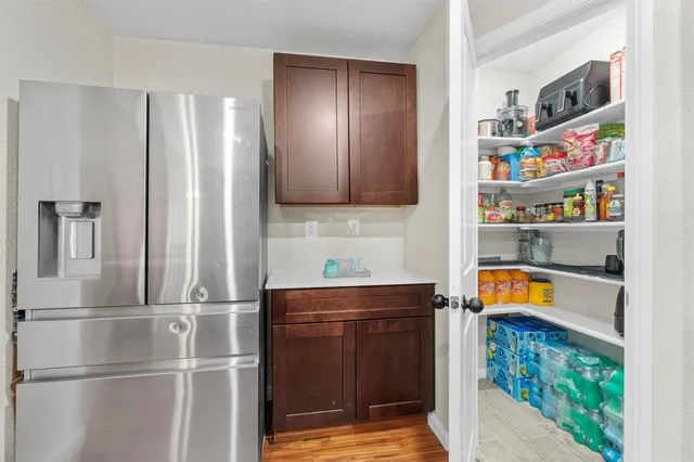a kitchen with refrigerator and cabinets