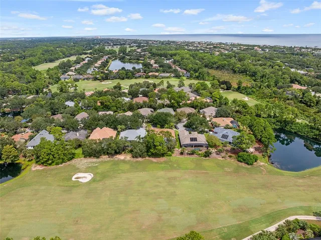 a view of a house with a big yard and large trees