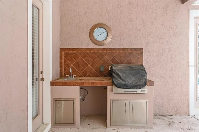 a view of a house with backyard and a tree