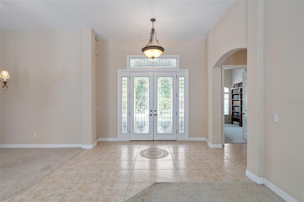 19 Lakeview Lane Palm Coast, FL 32137 - Photo 5 of 81 an empty room with floor to ceiling windows and wooden floor