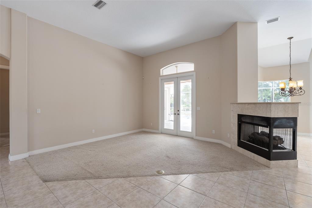 19 Lakeview Lane Palm Coast, FL 32137 - Photo 51 of 81 a view of an empty room with a fireplace and a window