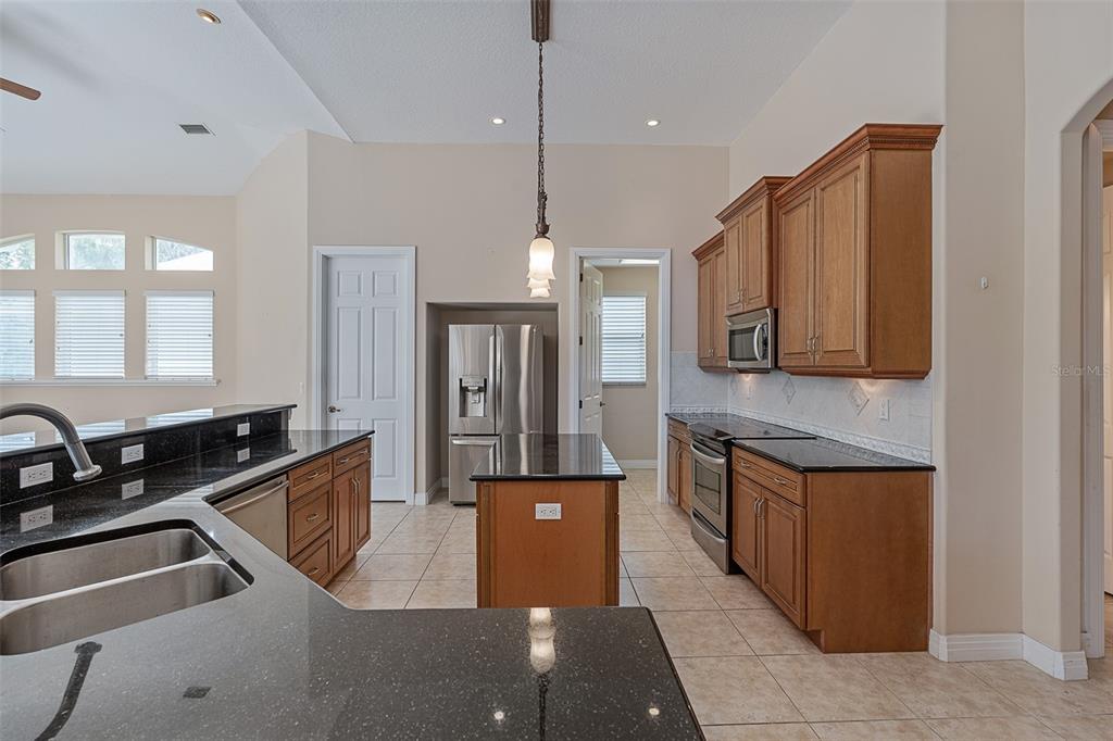 19 Lakeview Lane Palm Coast, FL 32137 - Photo 61 of 81 a kitchen with stainless steel appliances granite countertop a sink a stove and a refrigerator