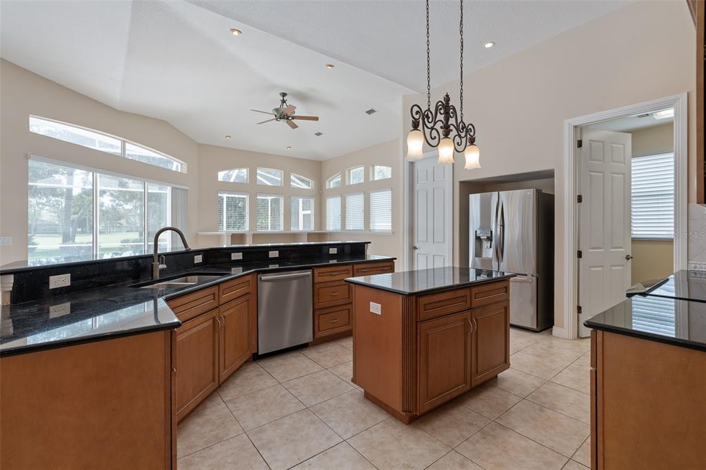 19 Lakeview Lane Palm Coast, FL 32137 - Photo 62 of 81 a large kitchen with kitchen island granite countertop a sink counter space and stainless steel appliances