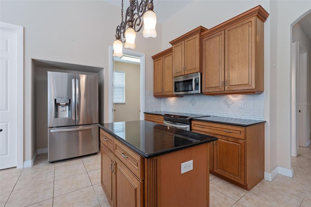 19 Lakeview Lane Palm Coast, FL 32137 - Photo 63 of 81 a kitchen with stainless steel appliances granite countertop a refrigerator a stove top oven a sink and dishwasher