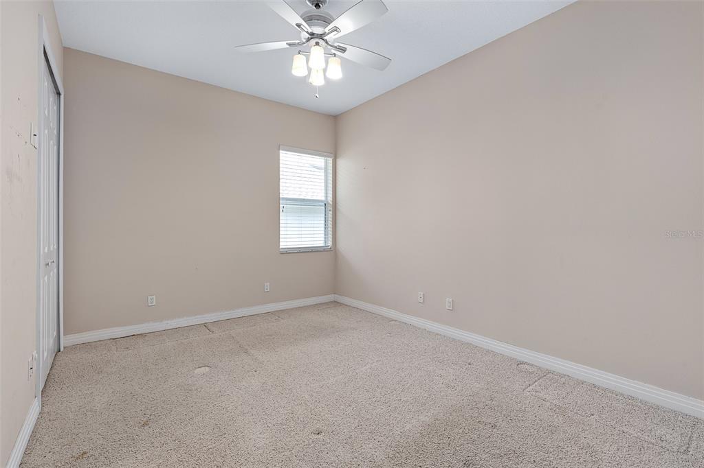 19 Lakeview Lane Palm Coast, FL 32137 - Photo 70 of 81 an empty room with a chandelier fan and windows