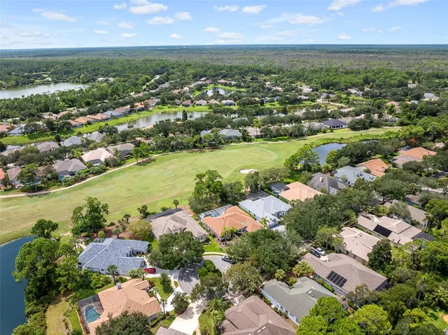 an aerial view of residential houses with outdoor space and river