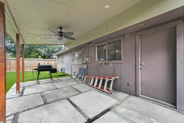 a view of a porch with furniture and a yard
