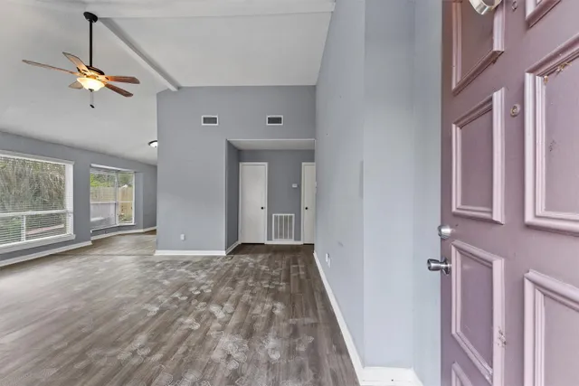 a view of a livingroom with a ceiling fan and window