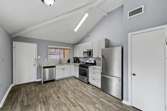 a kitchen with a refrigerator stove and sink