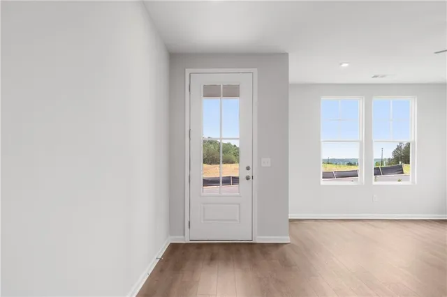 a large kitchen with stainless steel appliances granite countertop a stove a sink and a refrigerator