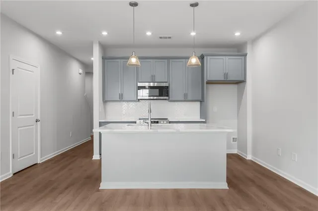 a kitchen with a sink and a microwave