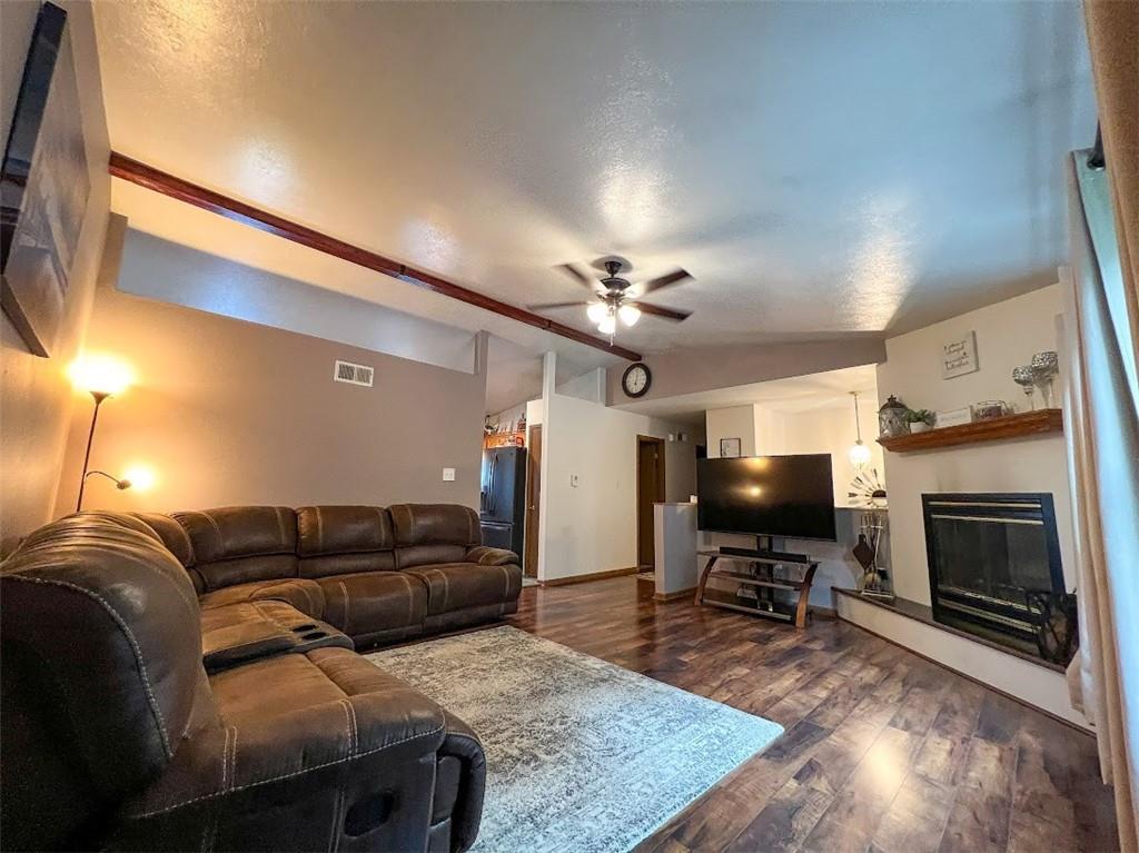 131 Leopard Road Evans City, PA 16033 - Photo 4 of 34 a living room with furniture a fireplace and a flat screen tv