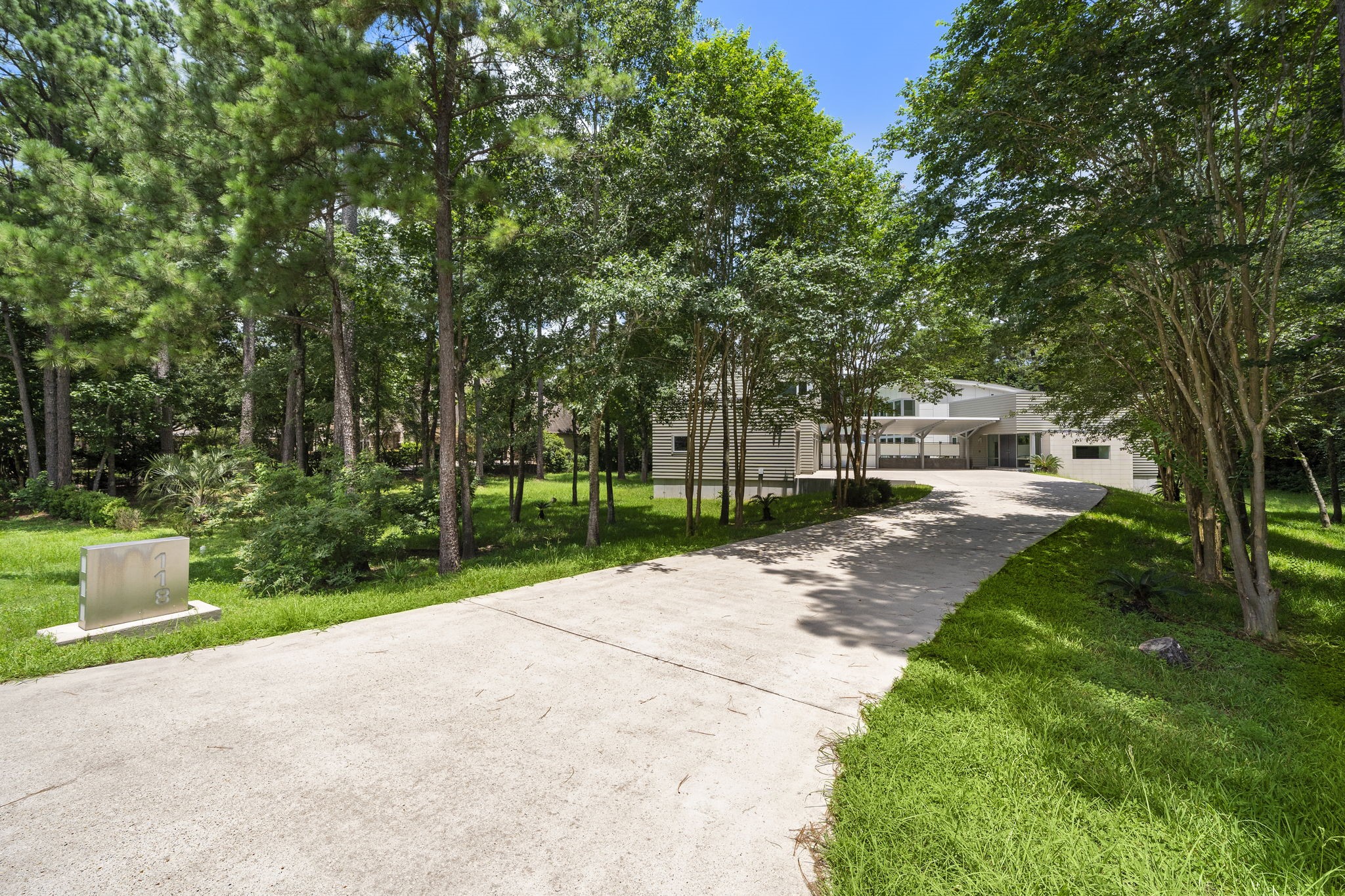 118 Angel Leaf Road The Woodlands, TX 77380 - Photo 46 of 50 Paved drive nestled under a canopy of tall trees and natural beauty.