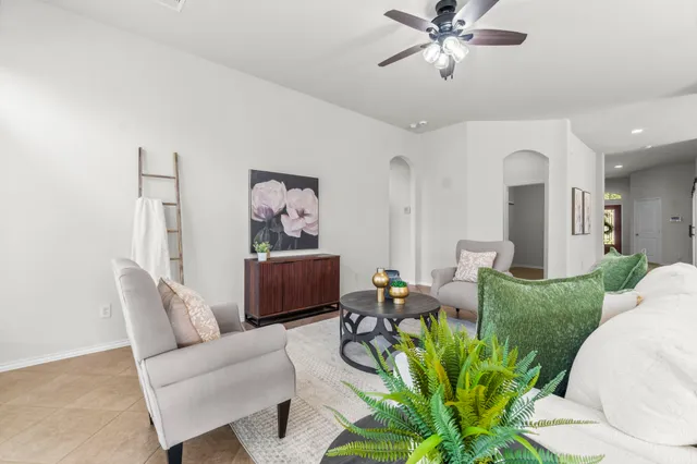 a kitchen with stainless steel appliances granite countertop a stove top oven a sink a dining table and chairs