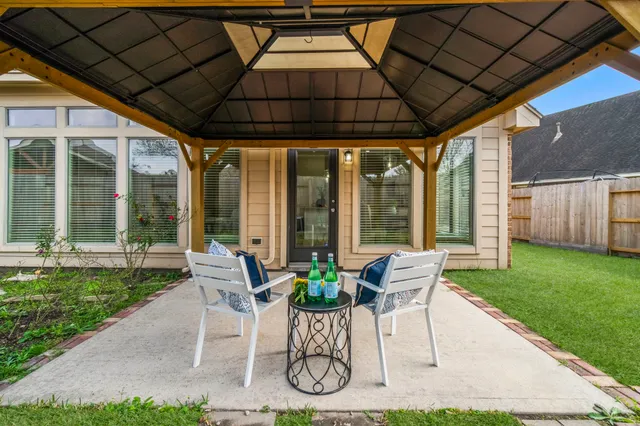 a view of an house with backyard porch and furniture