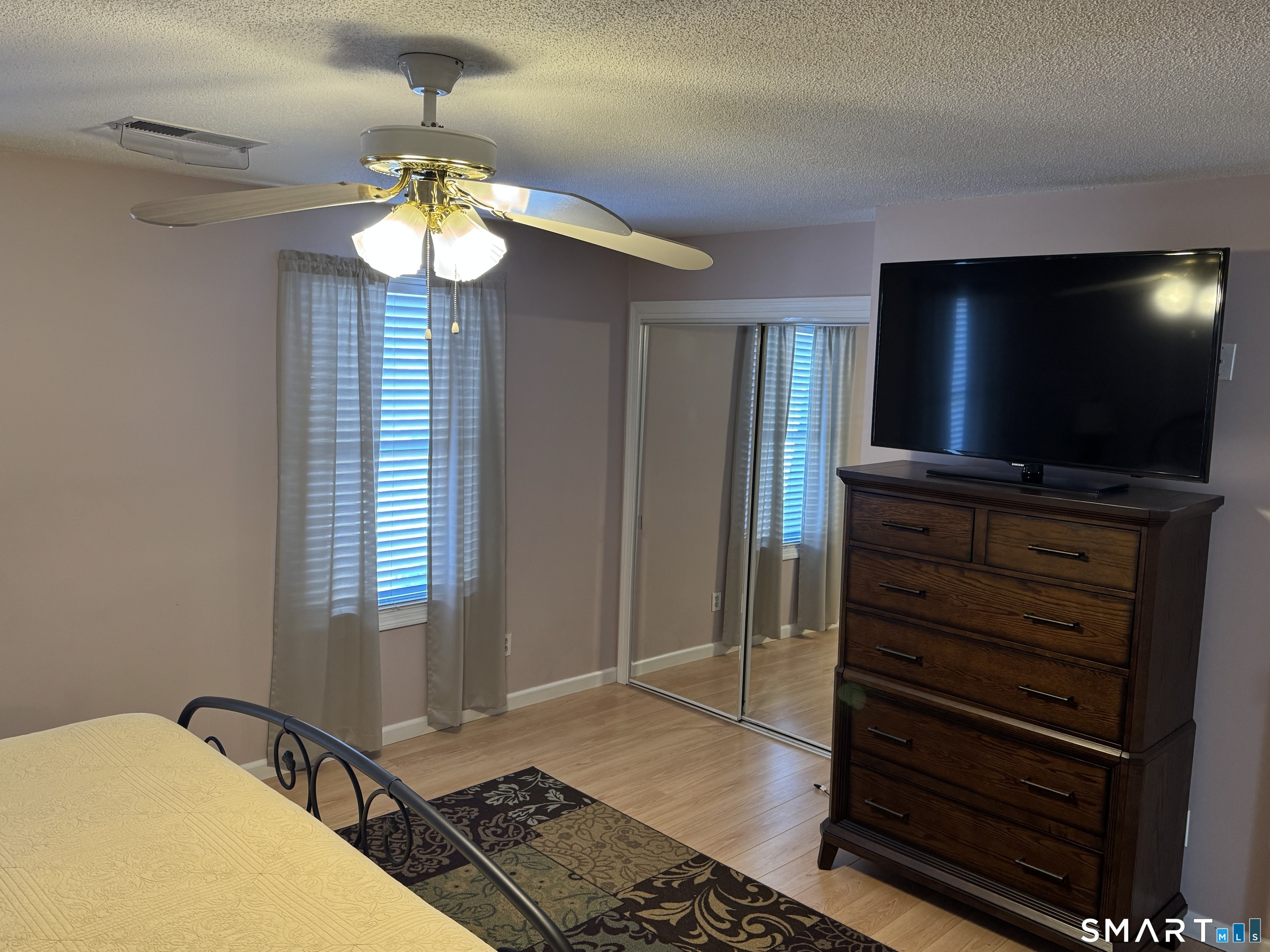 7 Bay Path Way, Unit 7 Branford, CT 06405 - Photo 6 of 14 a view of a livingroom with wooden floor and a flat screen tv