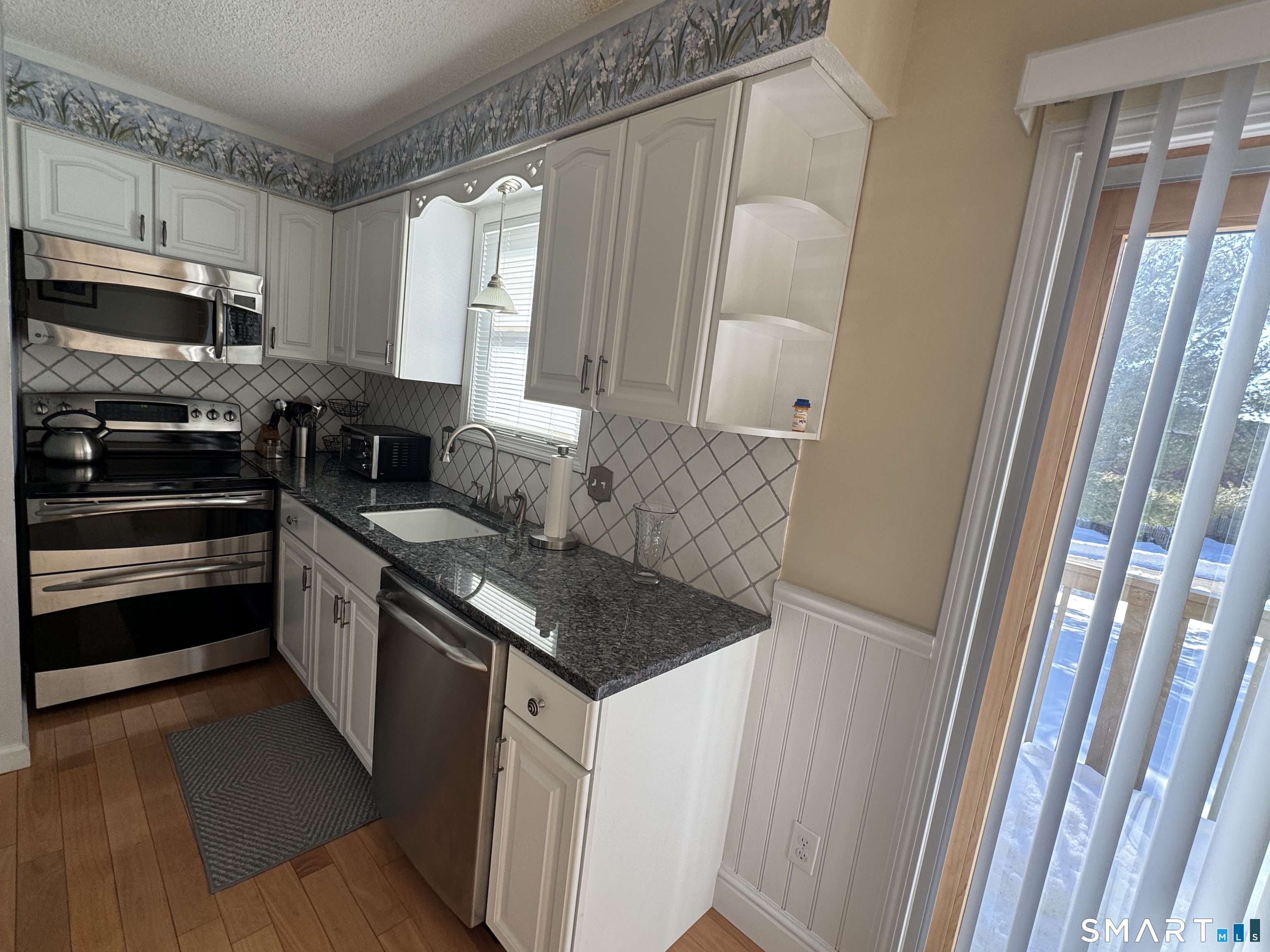 7 Bay Path Way, Unit 7 Branford, CT 06405 - Photo 7 of 14 a kitchen with stainless steel appliances granite countertop a stove a sink and a refrigerator