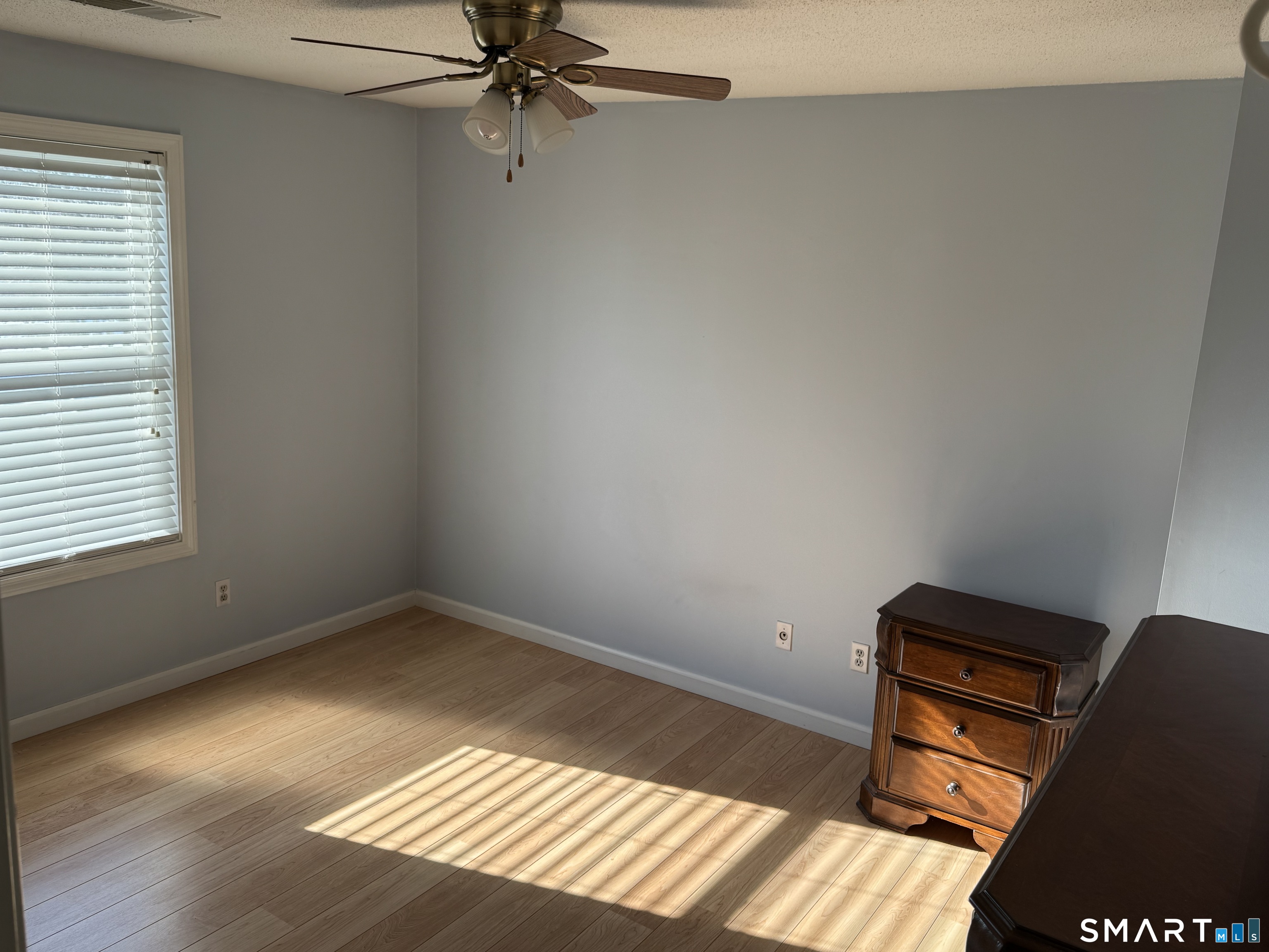 7 Bay Path Way, Unit 7 Branford, CT 06405 - Photo 9 of 14 wooden floor in an empty room