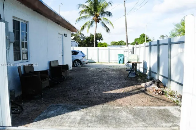 a view of a backyard with a sitting area