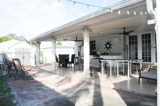 an outdoor space with lots of tables and chairs