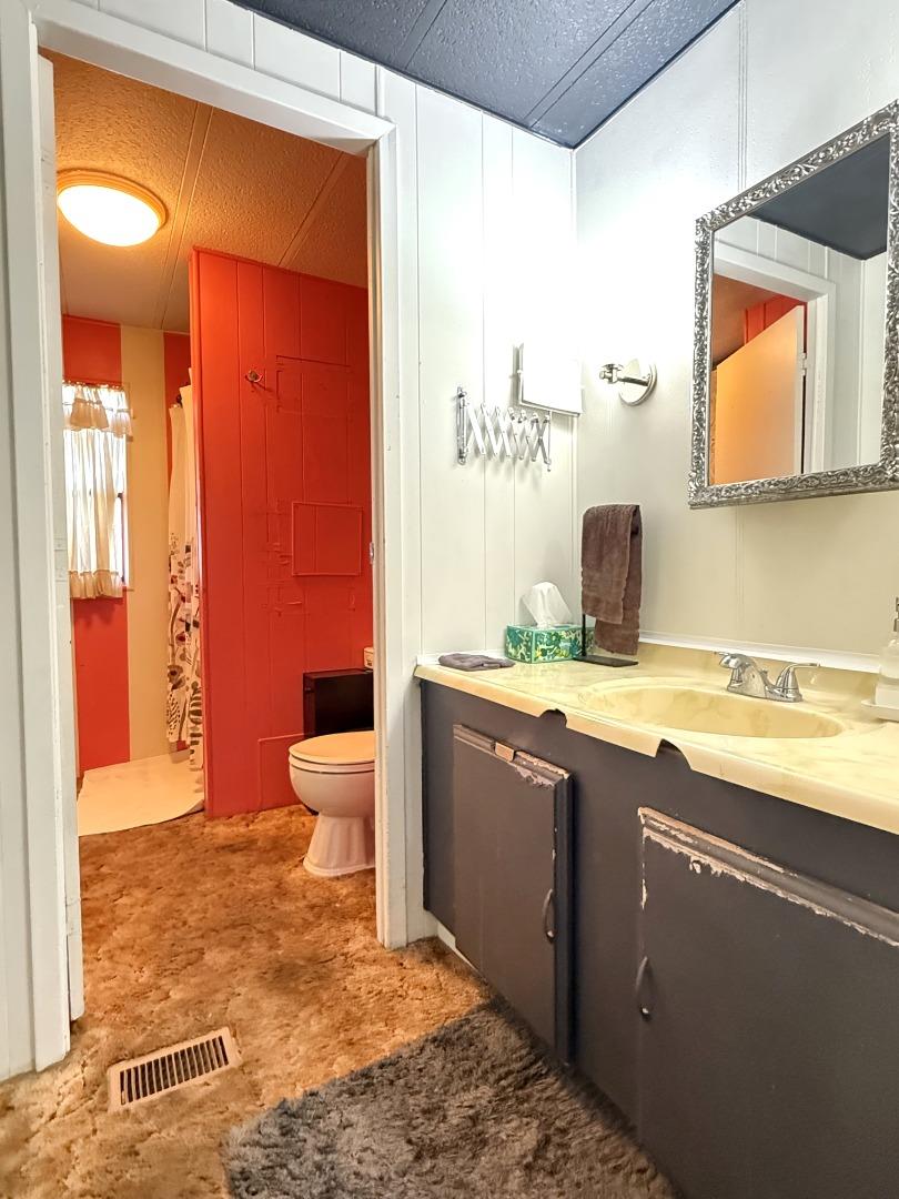 5450 Monterey Road, Unit 143 San Jose, CA 95111 - Photo 11 of 21 a bathroom with a granite countertop sink and a mirror