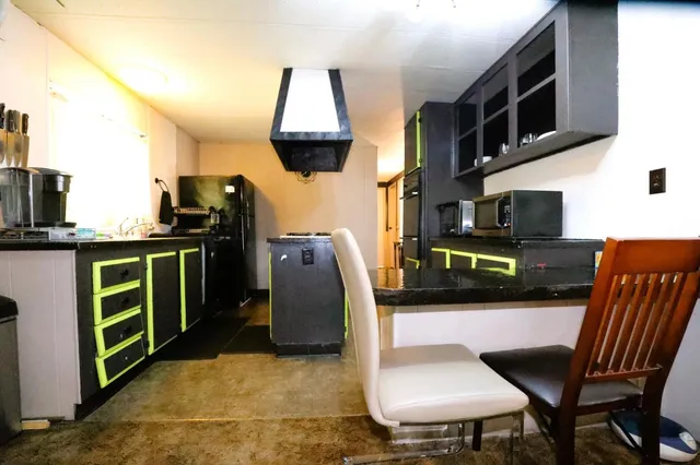 a view of kitchen with furniture and a microwave