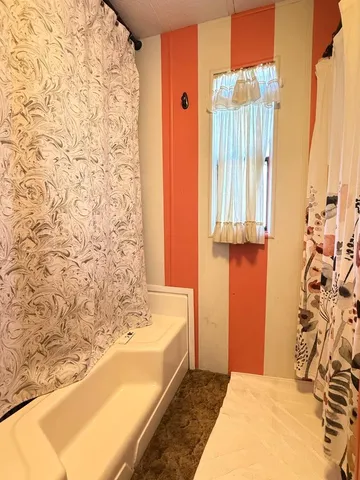 a bathroom with a bathtub and shower