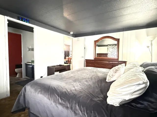 a bed sitting in a bedroom next to a window