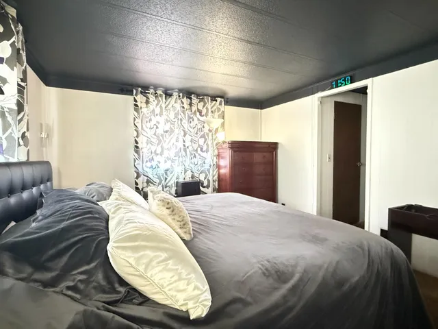 a bedroom with a bed and a dresser