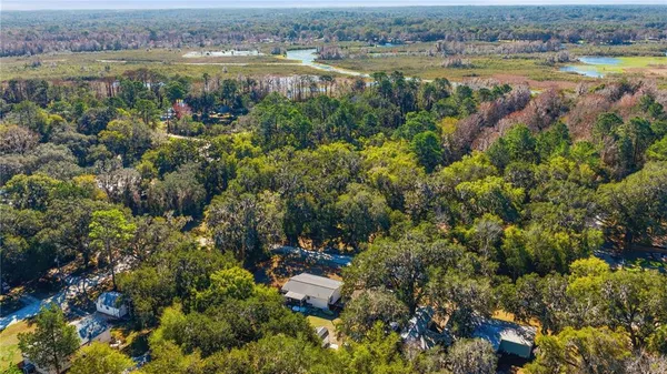 an aerial view of a houses with a lake view
