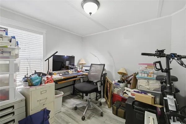 a view of a workspace with furniture and a window