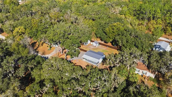 an aerial view of a house with a yard