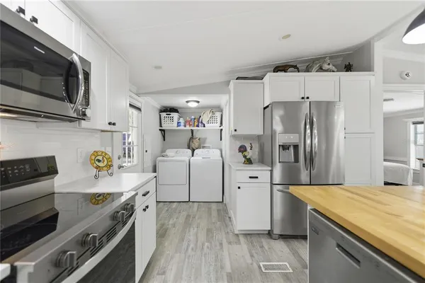 a kitchen with a sink a stove and chairs