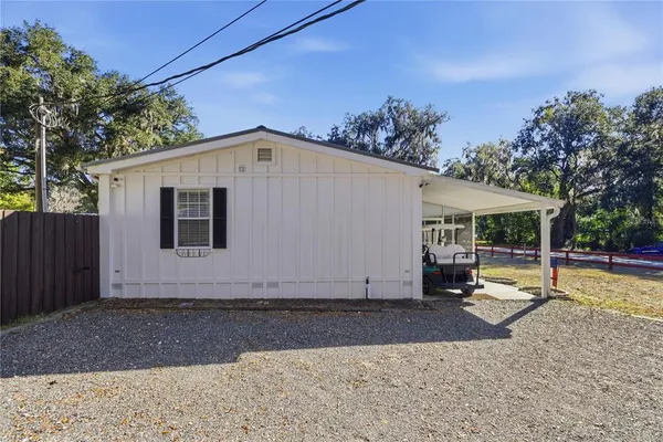 a backyard of a house with table and chairs