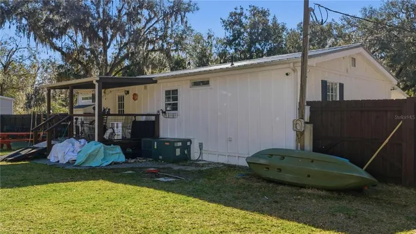 a backyard of a house with barbeque oven and outdoor seating