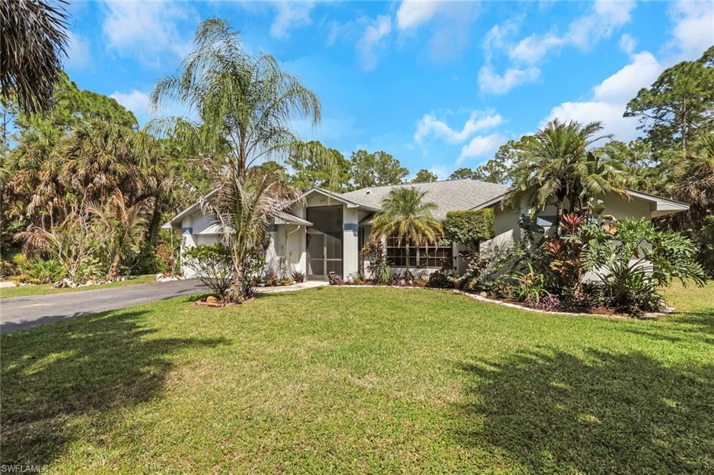 760 1st Street Northwest Naples, FL 34120 - Photo 1 of 36 a view of a house with a yard