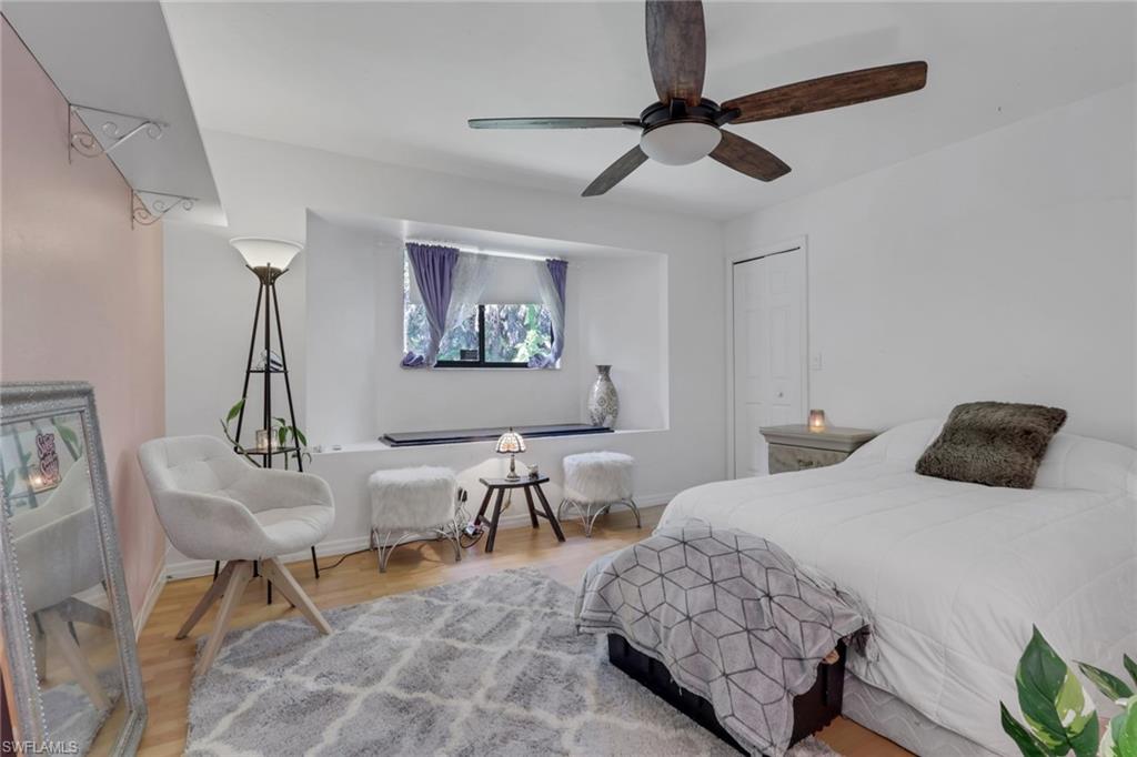 760 1st Street Northwest Naples, FL 34120 - Photo 13 of 36 a bedroom with a bed a desk and chair