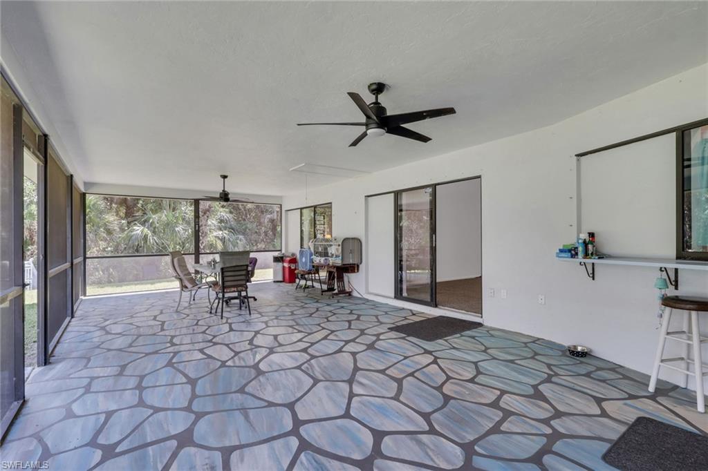 760 1st Street Northwest Naples, FL 34120 - Photo 17 of 36 a living room with a large window and chairs