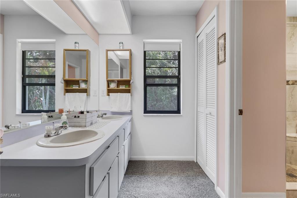 760 1st Street Northwest Naples, FL 34120 - Photo 19 of 36 a bathroom with a sink double vanity and a window