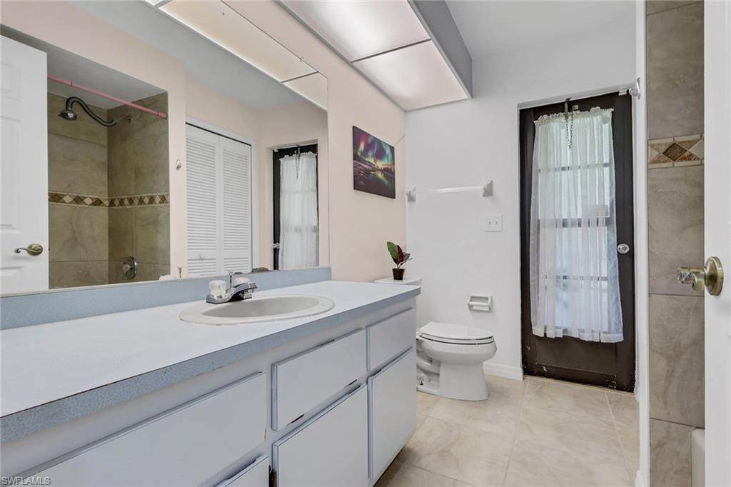 760 1st Street Northwest Naples, FL 34120 - Photo 20 of 36 a bathroom with a toilet a sink and mirror