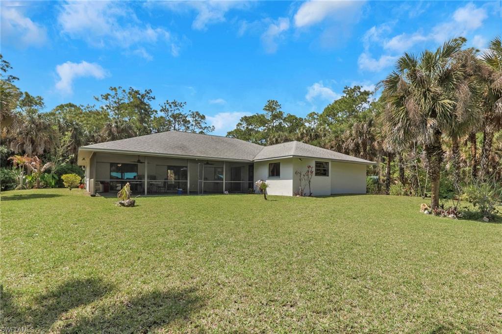 760 1st Street Northwest Naples, FL 34120 - Photo 26 of 36 a front view of a house with a garden