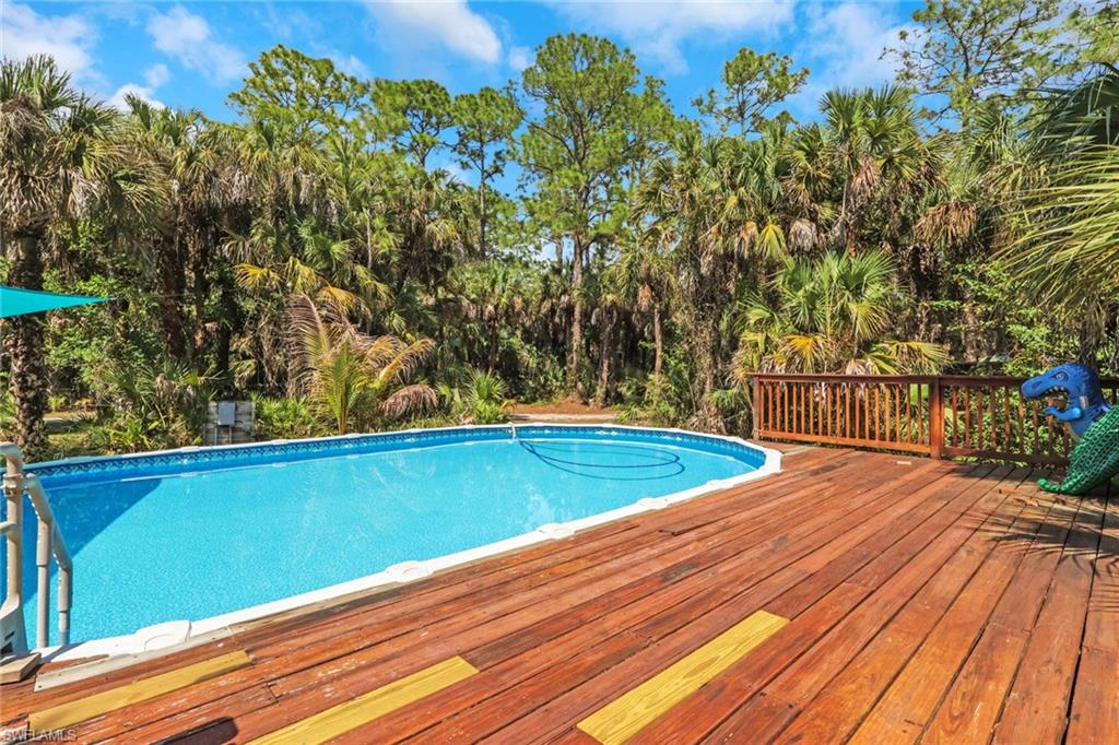 760 1st Street Northwest Naples, FL 34120 - Photo 4 of 36 a view of a pool with a yard
