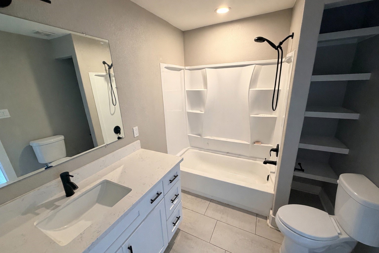 5105 Oak Avenue Pasadena, TX 77503 - Photo 4 of 15 a bathroom with a sink a toilet a tub and shower