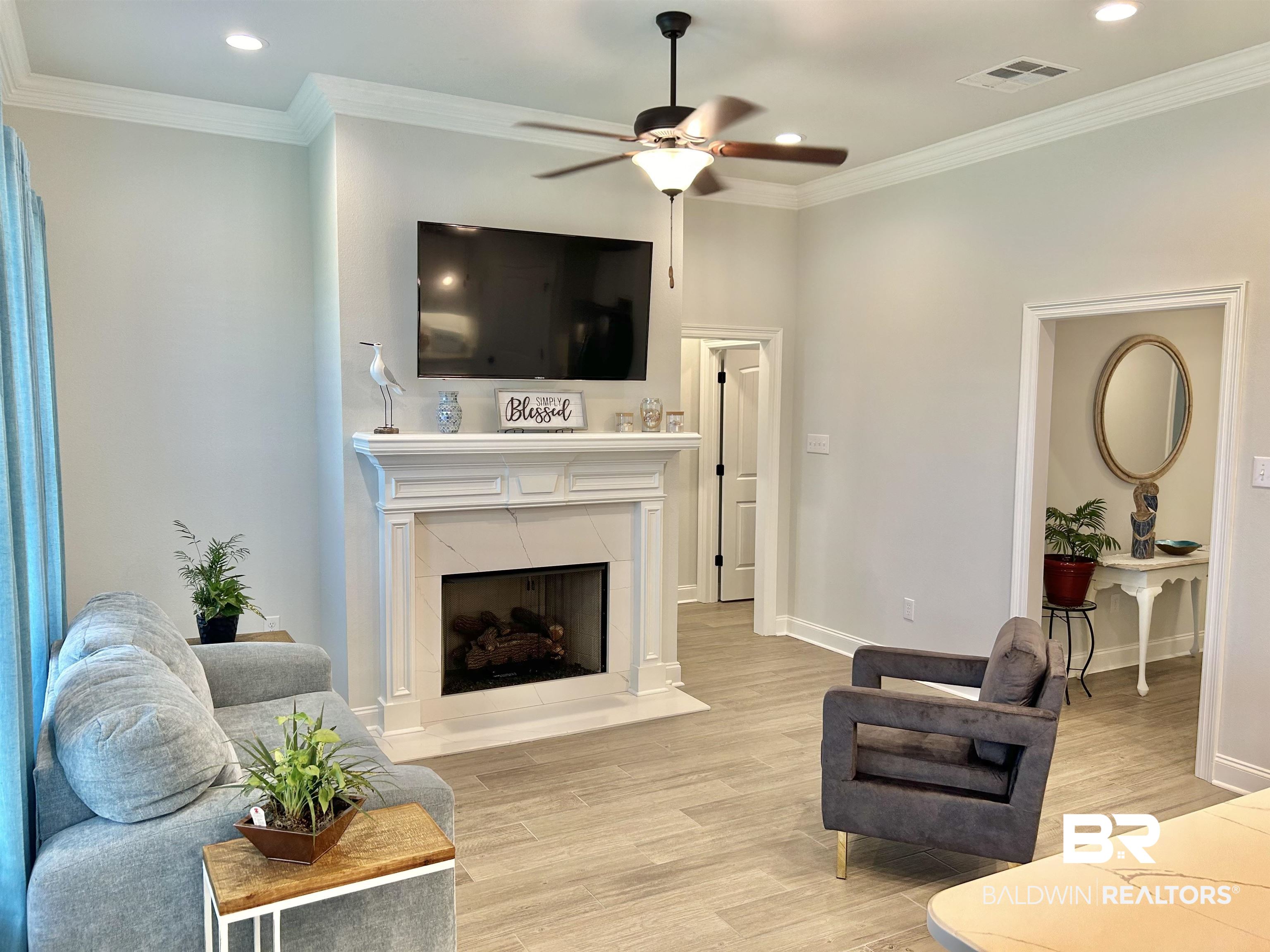1398 Aldon Street Foley, AL 36535 - Photo 29 of 32 Living room with light wood look tile floors, crown molding, and ceiling fan