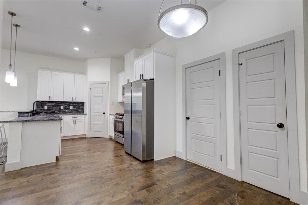 6043 Rivendell Drive Frisco, TX 75035 - Photo 6 of 38 a view of a kitchen with refrigerator and white cabinets
