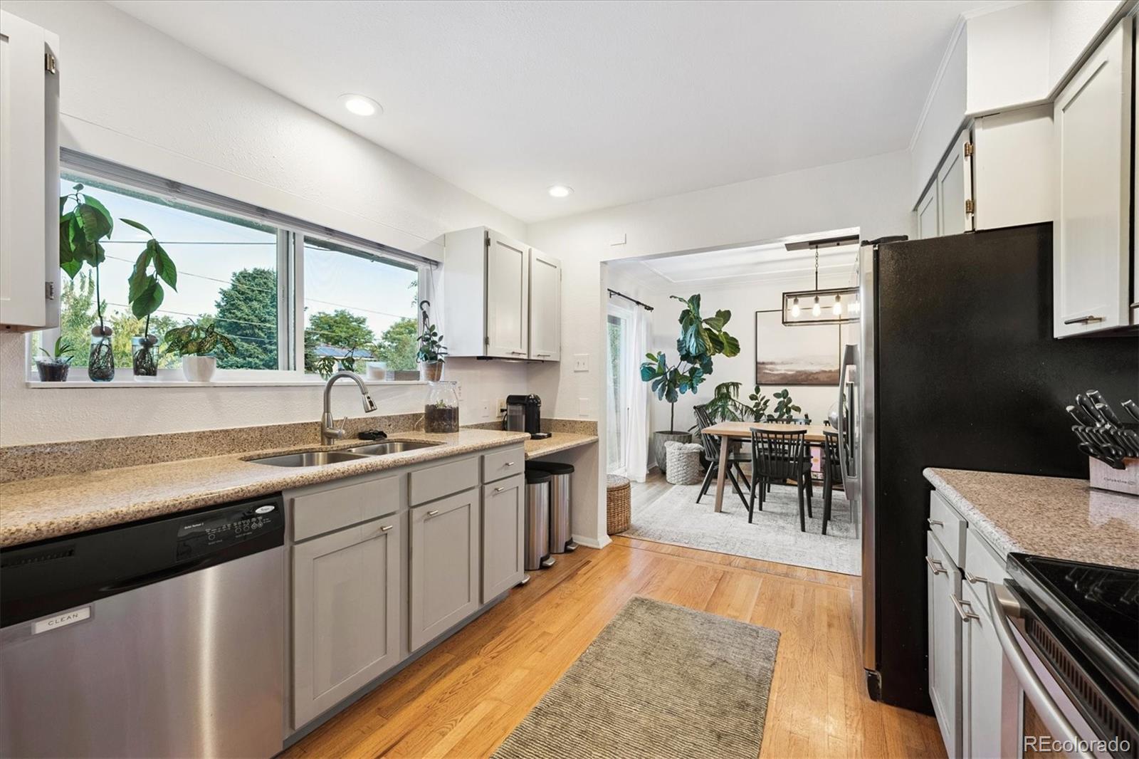 3675 South Hibiscus Way Denver, CO 80237 - Photo 16 of 50 a kitchen with stainless steel appliances granite countertop sink stove top oven and cabinets