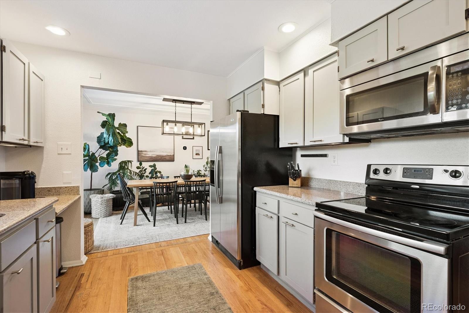 3675 South Hibiscus Way Denver, CO 80237 - Photo 17 of 50 a kitchen with a stove microwave and refrigerator