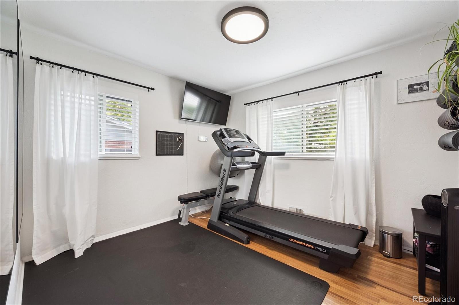 3675 South Hibiscus Way Denver, CO 80237 - Photo 18 of 50 a room with gym equipment and a window