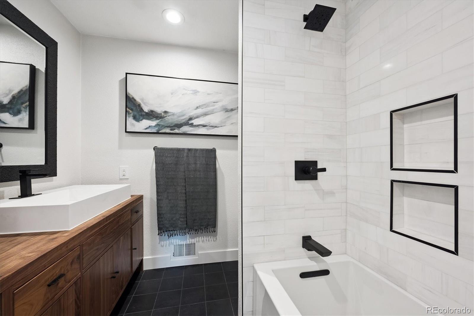 3675 South Hibiscus Way Denver, CO 80237 - Photo 19 of 50 a bathroom with a sink a mirror and a shower